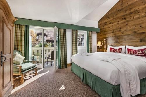 a large bedroom with a large bed and a chair at Vail Sonnenalp King Hotel Room in Vail