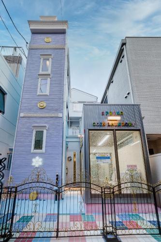 a blue building with a gate in front of it at Diamond Moon Palace Takadanobaba,2 stops to Shinjuku in Tokyo