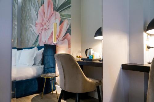 a hotel room with a bed and a desk with a chair at The Unique Hotel in Milan