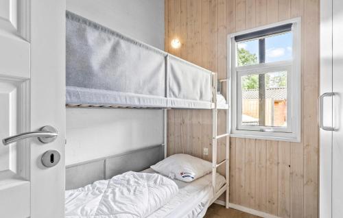 a bedroom with two bunk beds and a window at Beautiful Home In Juelsminde With Sauna in Sønderby