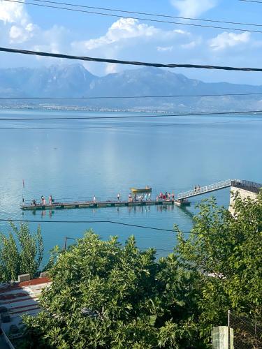 a dock on a lake with people on it at Natyra te Eti in Shkodër