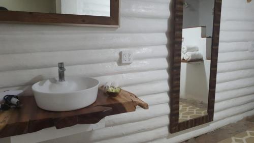 a bathroom with a sink on a wooden counter at Estancia Los Amigos Valle de Guadalupe in Valle de Guadalupe