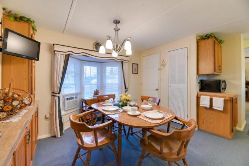 a kitchen and dining room with a table and chairs at Quaint Lakemont Retreat 1 Mi to Seneca Lake! in Lakemont