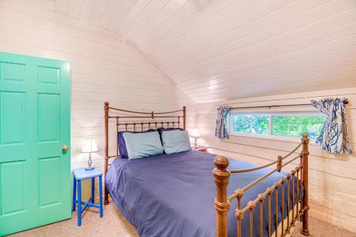a bedroom with a bed and a green door at Riverfront Home with Fire Pit and Deck in Lansing in Lansing