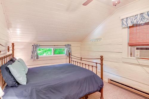 a bedroom with a bed and a window at Riverfront Home with Fire Pit and Deck in Lansing in Lansing