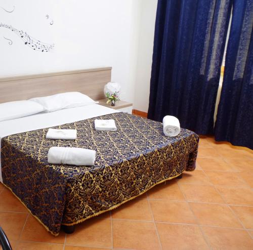 a bedroom with a bed with two towels on it at Hotel Centrale in Milan