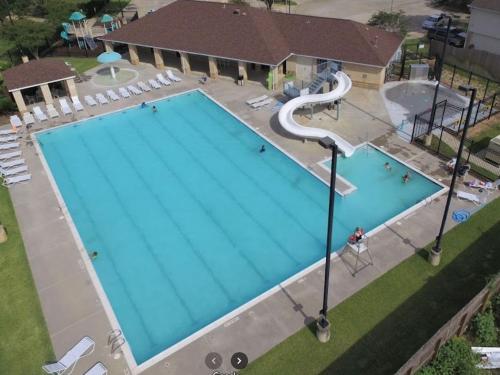 an overhead view of a large swimming pool at Cozy 3 bedrooms House - Feel Like Home in Houston