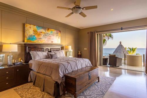 a bedroom with a bed with a view of the ocean at Villa Alegria in El Pueblito