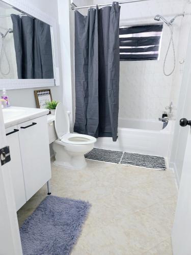 a bathroom with a toilet and a sink and a shower at Comfy Stylish Room in the Heart of Vancouver- Private Parking, Self Check-in & just 4 mins to Metrotown! in Vancouver