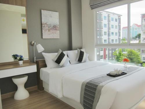 Ένα ή περισσότερα κρεβάτια σε δωμάτιο στο Banyan Residence
