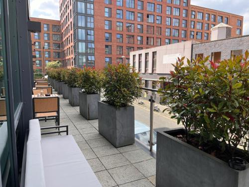a row of potted plants on the balcony of a building at B&B HOTEL Birmingham Centre in Birmingham