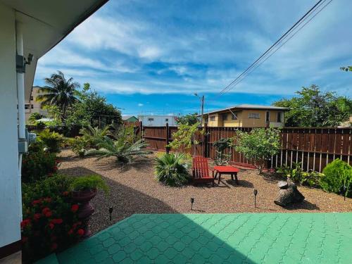a backyard with a bench and a table at CentralCity "Haven" Private Home & Pool in Belize City