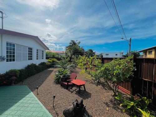 a backyard with a picnic table and a bench at CentralCity "Haven" Private Home & Pool in Belize City