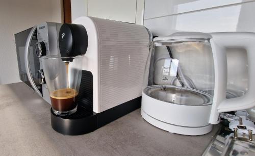 a coffee maker sitting next to a toaster at 2 Bedroom Cityview Apartment PS5-QLED TV-Parking in Chemnitz