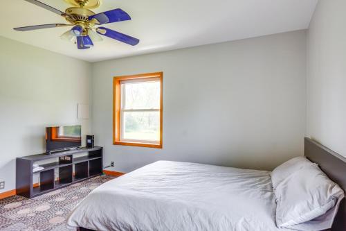 a bedroom with a bed and a ceiling fan at Pet-Friendly New Berlin Retreat with Patio and Yard! in New Berlin