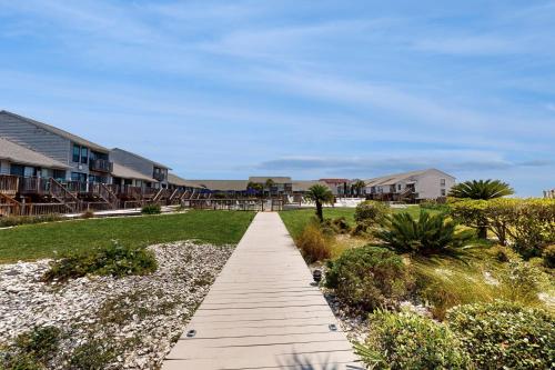 a walkway leading to a beach with houses at Ocean Mile L7 Gulf Beach Getaway in St. George Island