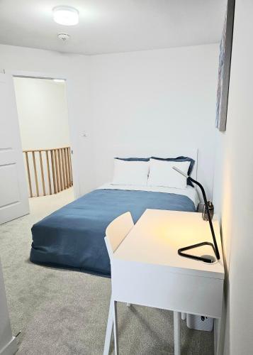 a bedroom with a bed and a desk with a desk at CEDAR Double Room with attached private Bathroom and Balcony in Toronto, ON, Canada in Toronto