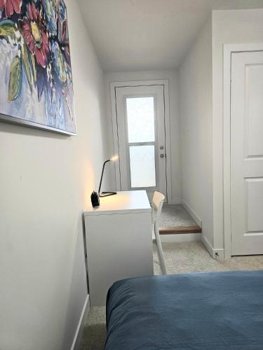 a bedroom with a bed and a desk and a window at CEDAR Double Room with attached private Bathroom and Balcony in Toronto, ON, Canada in Toronto