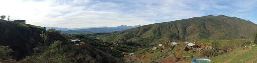 a view of a mountain with houses on a hill at Asclepia lodge spa in Quebrada Escobares