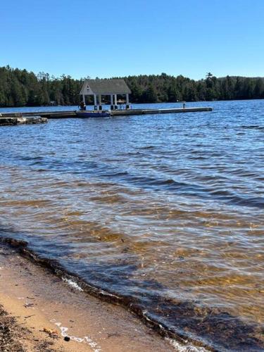 a house on a dock in a large body of water at Whispering Pines Muskoka 3BR 3 Ensuite Baths in Dwight