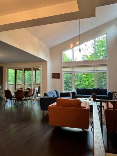 a living room with a couch and a table at Whispering Pines Muskoka 3BR 3 Ensuite Baths in Dwight