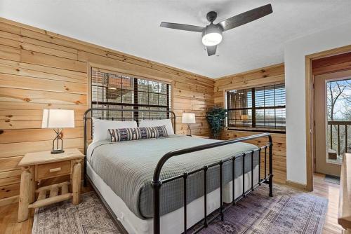 a bedroom with a bed and a ceiling fan at Pitch Perfect in Sevierville