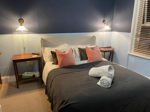 a bedroom with a large bed with pillows at Beach Hideaway in Shanklin
