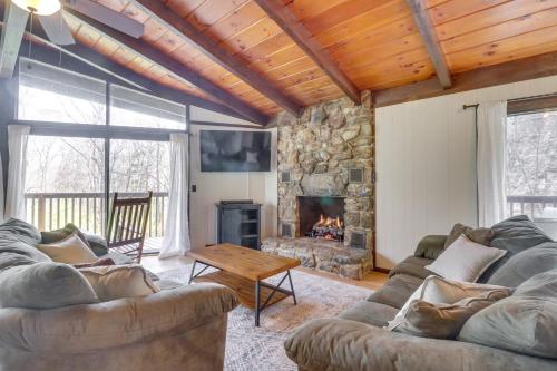 a living room with a couch and a fireplace at McGaheysville Vacation Rental Yard and Fire Pit! in McGaheysville