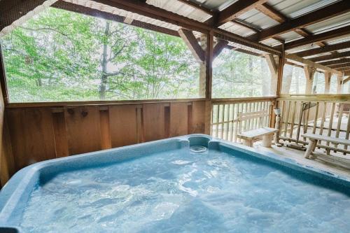 a jacuzzi tub in a wooden house at Big Kahuna Lodge cabin in Sevierville