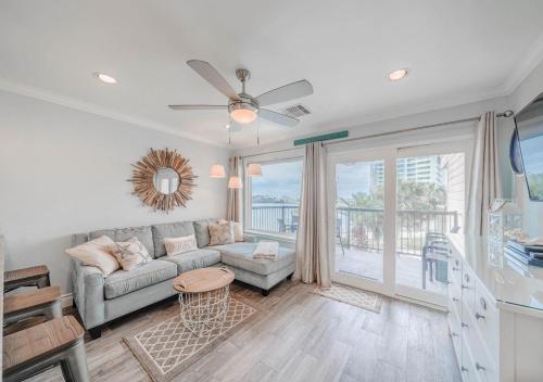 a living room with a couch and a table at Ocean View Luxury Steps to Beach in Galveston