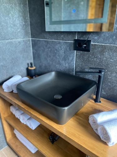 a black sink on a counter in a bathroom at Adria Nord Chalets in Žabljak
