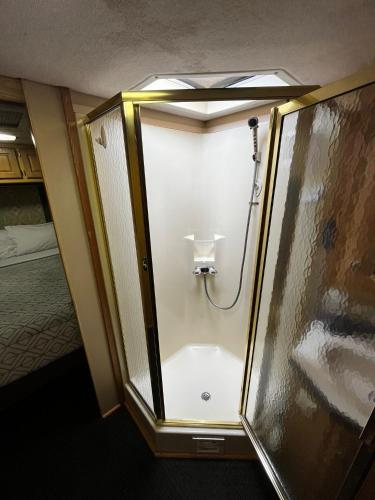 a shower in a room with a glass wall at Cozy Private Motorhome near The Falls & Baptist with Parking in Miami