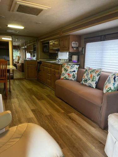a living room with a couch and a kitchen at Cozy Private Motorhome near The Falls & Baptist with Parking in Miami