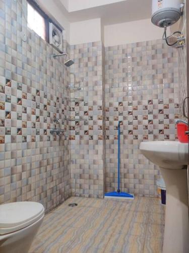 a bathroom with a toilet and a sink at ANAisha mansION Near Helipad Rajpur Road shastradhara Hill View in Dehradun