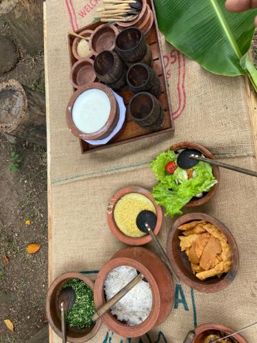 a table topped with bowls of different types of food at Moonshade Handapanagala in Monaragala