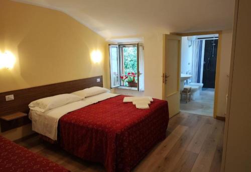 a bedroom with a large bed with a red blanket at Amoroso's house, affittacamere in Caramanico Terme