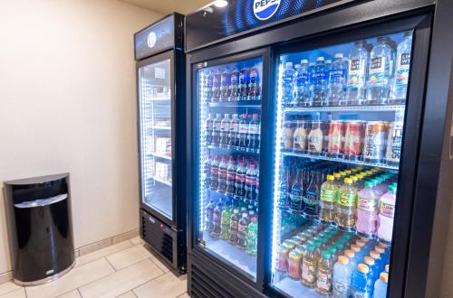 a refrigerator filled with lots of soda and sodas at Cobblestone Inn & Suites - Winters in Winters