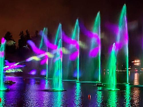 a group of water fountains with purple and green at L'AvantGardiste, Spacious 6 bedrooms duplex, panoramic view in Crans-Montana