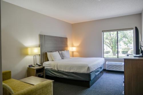 a hotel room with a bed and a window at Baymont by Wyndham O'Fallon St. Louis Area in O'Fallon