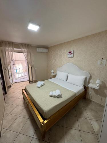 a bedroom with a large bed with towels on it at Vittoria's home near Maradona mural in Naples