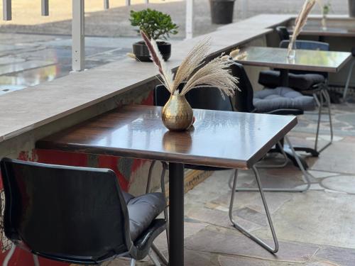 a table with a vase sitting on top of it at Hilde Apartments in Rheinhausen