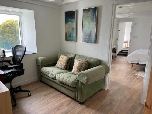 a living room with a couch and a bedroom at Pier Cottage with private water access to Colla Pier in Schull