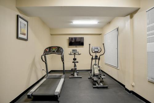 a gym with two exercise bikes in a room at Baymont by Wyndham O'Fallon St. Louis Area in O'Fallon