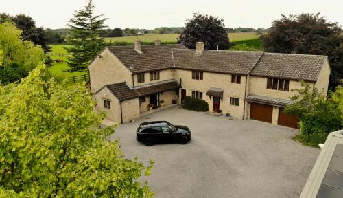 a black car parked in front of a house at Stud House in Private Country Estate near Bruton in Gillingham