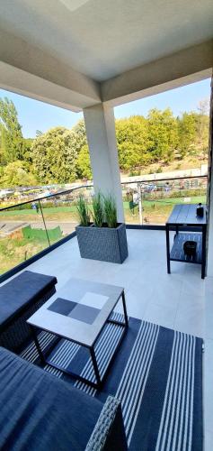 a patio with a table and a view of a park at Studio apartmani Anika in Vrdnik