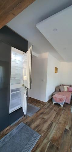 a living room with a couch and a table at Studio apartmani Anika in Vrdnik