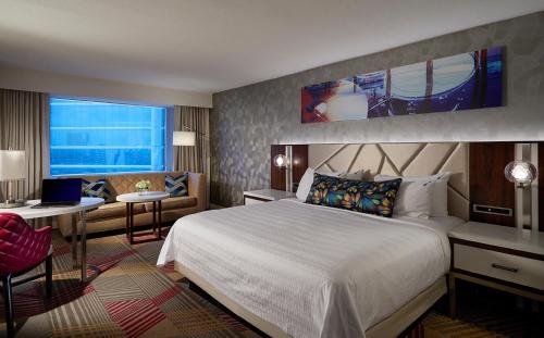a hotel room with a large bed and a desk at Hard Rock Hotel & Casino Atlantic City in Atlantic City