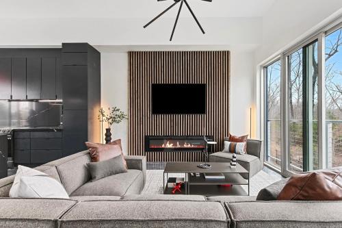 a living room with a couch and a fireplace at Grand Prix Grandeur at AMP in Dawsonville