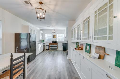 a kitchen with white cabinets and a refrigerator at 3 Mi to Baylor U Home with Shared Yard in Waco