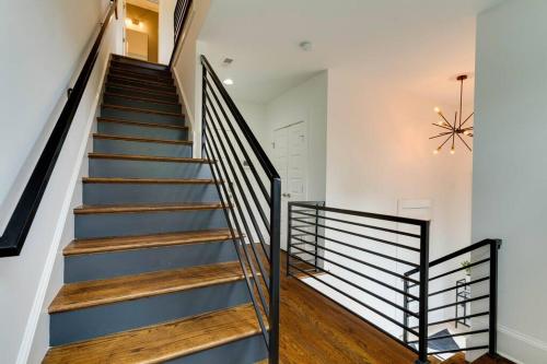 a staircase in a home with wooden floors and a chandelier at Perfectly located-Walk to bars- Close to Broadway in Nashville